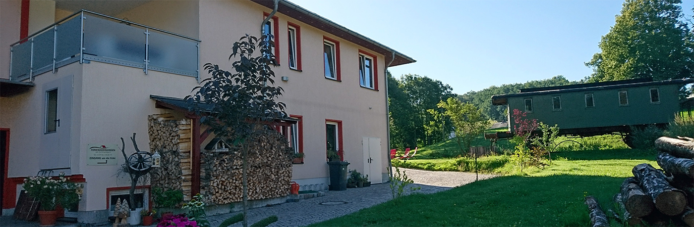 Haus und bewohnbarer Eisenbahnwaggon nebenan
